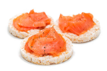 Tasty Rice Cake Sandwiches with Fresh Salmon Slices Isolated on White. Easy Breakfast and Diet Food. Crispbread with Red Fish. Healthy Dietary Snacks - Isolation