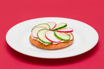 Crispy Cracker Sandwich with Cream Cheese, Fresh Cucumber and Radish on White Plate