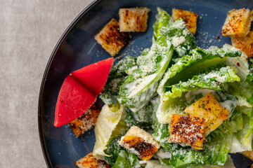 Caesar salad is a green salad of romaine lettuce and croutons dressed with mustard, Parmesan...
