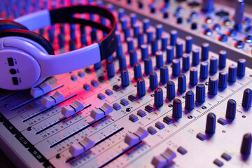 Sound mixer and headphones on audio mixing console. Music equipment concept