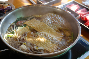 Shabu-shabu with various ingredients is boiling.