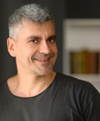 Fototapeta premium Happy handsome middle aged man with stubble smiling