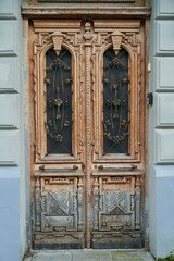 Fototapeta na wymiar Old carved wooden door in stone building in Batumi, Georgia