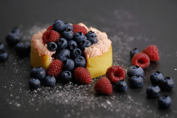 Cake with cream covered with juicy berries.