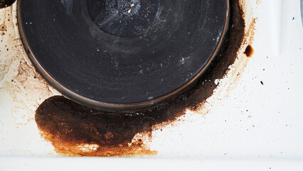 Close-up of a dirty stove with leftover food. Dirty gas stove with grease stains, old grease stains, fried stains and oil splashes.Macro photo.Texture