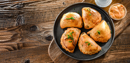 Composition with a plate of oven-baked pierogi