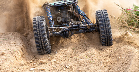 Off road vehicle motion the wheels tires off road dust cloud in desert, Offroad vehicle bashing through sand in the desert, off oad racing.