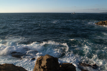 In the blue stormy sea the ship sails away