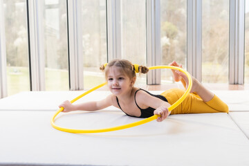 Little blonde girl with piggy tails playing with hula hoop © stivog