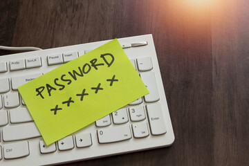 note paper of password key sticked on computer keyboard, security password management