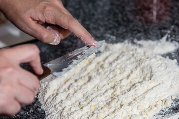 woman mixing flour with butter to prepare a cake
