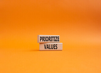 Prioritize values symbol. Concept word Prioritize values on wooden blocks. Beautiful orange background. Business and Prioritize values concept. Copy space