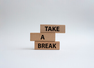 Take a break symbol. Concept words 'Take a break' on wooden blocks. Beautiful white background....