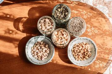 Cashew nuts, pistachios, sunflower seeds and pumpkin seeds in a jars and bowl