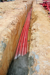 SELANGOR, MALAYSIA -AUGUST 2, 2021: Heavy-duty underground pipes lay in the ground at a...