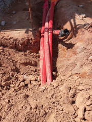SELANGOR, MALAYSIA -AUGUST 2, 2021: Heavy-duty underground pipes lay in the ground at a construction site. this pipe will be the path to the high voltage electric cable.