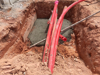 SELANGOR, MALAYSIA -AUGUST 2, 2021: Heavy-duty underground pipes lay in the ground at a construction site. this pipe will be the path to the high voltage electric cable.
