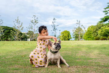 girl with dog at field against cloudy sky.