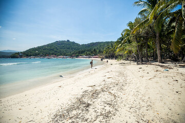 Travaler walking in Las gatas beach at Ixtapa Zihuatanejo