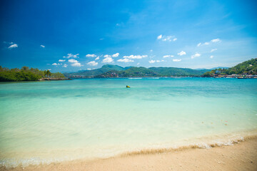 Travaveler walking in the waves, Playa Las Gatas Zihuatanejo, jungle sea