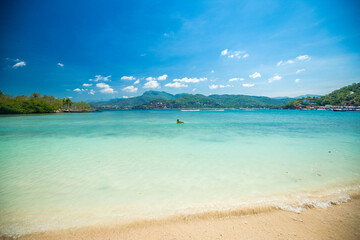 Travaveler walking in the waves, Playa Las Gatas Zihuatanejo, jungle sea