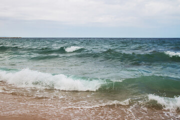 Seascape. Sea coast. Waves. Sea water. Horizon. Sky. Spain. Mediterranean Sea.