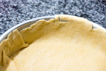 Details on a pre-baked pastry before it get filled with onion sauce to cook a cake.