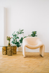 Living room with green plants and an empty large armchair, home comfort, interior details