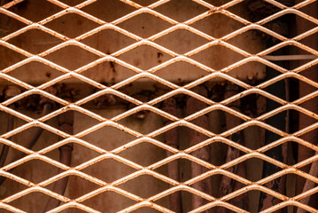 Industrial background texture, a close-up of the rusty rhombic sheet metal grille of an old mining truck