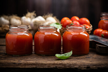 Fototapeta na wymiar Fresh Tomato sauce and juice . On a wooden background.