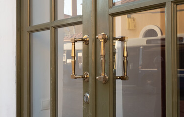 Unusual glass door and dorhandle. Bright historical petersburg. Vintage metal unusual doors