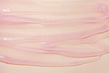 Cosmetic beige shimmering oil gel pink texture background - obrazy, fototapety, plakaty