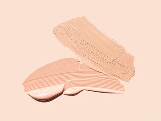 Foundation or bb cc cream and matte concealer texture swatch on beige background