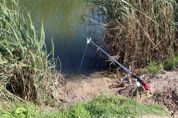 Fishing rod on the shore of the lake.
