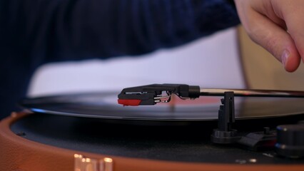 Close-up of a needle for playing music from vinyl records. They put the record in the player and it...