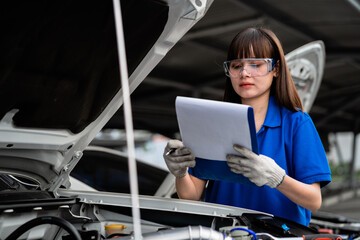 Portrait of a professional female auto mechanic repairing a car. Service concept. Auto repair service concept.