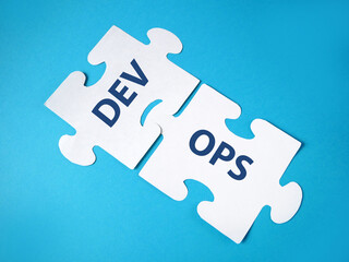 puzzle with words Dev and Ops. DevOps Concept for software engineering culture and practice of...