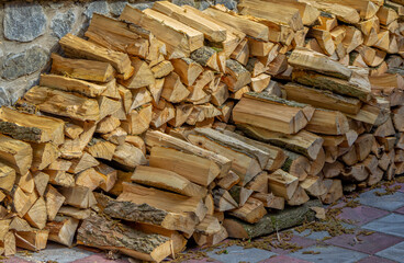 A pile of fire wood chopped and prepared for burning and heating the house in rural area in winter.