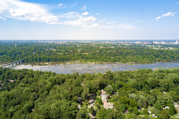 view of the river in the city nature aerial drone bridge water blue sky rocks luscious green trees virginia sunny day