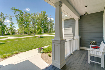 Traditional porch with green grass yard