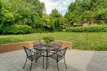Patio with flowers paved floor brick wall in garden