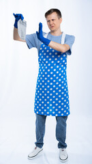 man in blue apron, rubber gloves, blue t-shirt, jeans. the homeowner is holding a dirty sock. White...