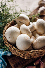 Fresh mushrooms, champignons in the basket, close up view