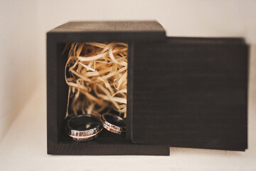 Two vintage wedding rings and wooden box
