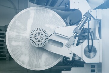 Modern machine for cutting large rolls of white paper for printing houses with roll high-speed...