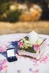 Wedding rings in a box and flowers on the table