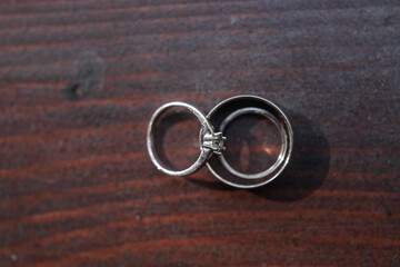 Two wedding rings on a wooden table