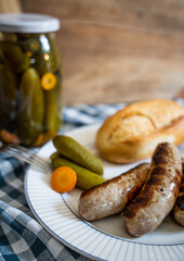 Roasted German sausages served with homemade pickled cucumbers and piece of bread 1