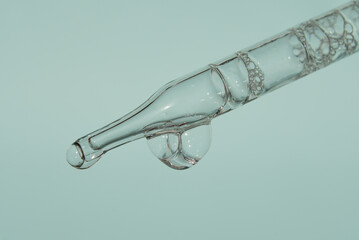 Pipette with liquid essence on a light background with air and bubbles inside. This is the consistency of micellar water. The concept of an extract for cosmetic purposes. High quality photo