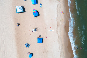 Aerial view top down of the a lifeguard stand and patrons at the Ocean View Community Beach